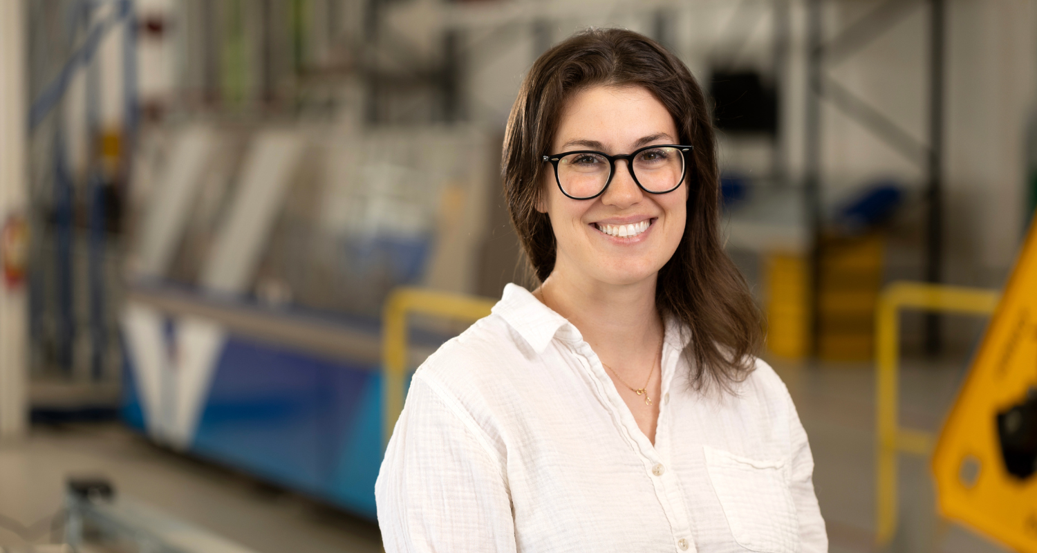 Headshot photo of Keely Lambert in M3C's manufacturing facility.